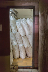 Food sugar in large white bags is stored in a food production warehouse