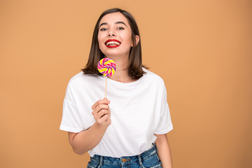 The young woman with colorful lollipop