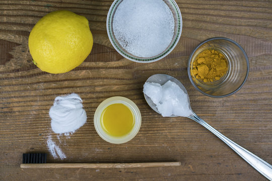 DIY toothpaste with ingredients, lemon, coconut oil, turmeric, baking soda, Xylitol and bamboo toothbrush