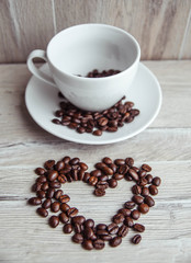 coffee beans love an cup on wooden background