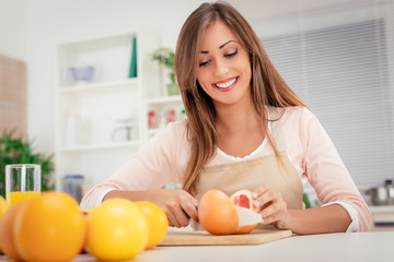 Obraz na płótnie Canvas Girl With Fruit In Kitchen