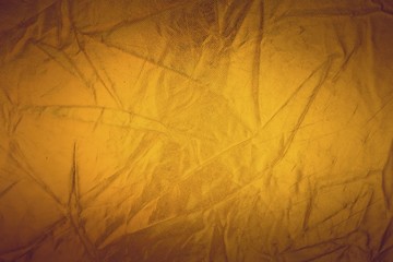 Gold thread on the fabric. Gold texture glitter background. Macro shot.