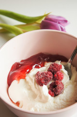 Cream cheese with raspberry jam in pink bowl vertical