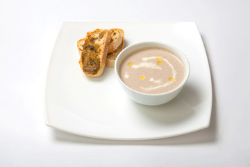 Soup puree mushrooms in a deep white plate