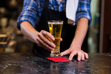 Bartender pouring the fresh beer in pub,barman hand at beer tap pouring a draught lager beer,beer from the tap,Filling glass with beer,fresh beer,pub.Bar.Restaurant.European bar.American bar.