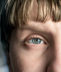 blue eye of the boy close up macro