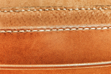 Stitch detail of an orange leather bag, concept handmade
