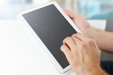 Male hand touching tablet screen