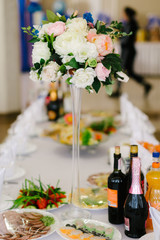 Vase with flowers on the wedding table