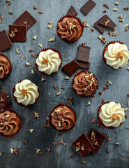 Chocolate and vanilla caramel cupcakes served with dark and white chocolate chippings