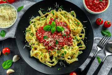 Homemade Hot Pasta with Marinara Sauce, Basil, Garlic, Tomatoes, parmesan cheese on plate.