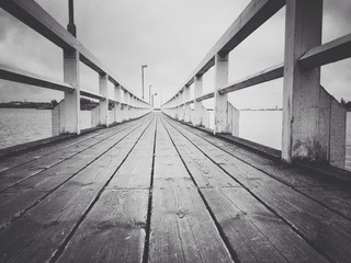 Perspective shot of the pier in black and white