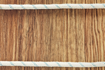 Double rope line on grunge wooden background with empty space for text.