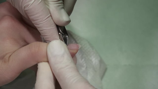 Manicure master working with a cuticula