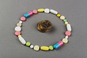 Circle created from colored pills with money. Medical concept