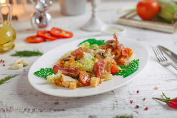 Salad with bacon mushrooms greens and cherry