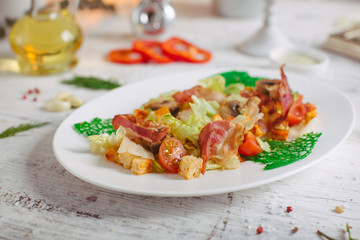 Salad with bacon mushrooms greens and cherry