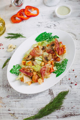 Salad with bacon mushrooms greens and cherry
