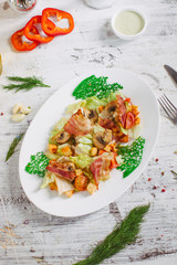 Salad with bacon mushrooms greens and cherry