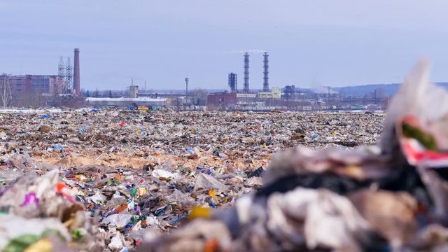 Garbage dump. Industrial factory on a background. Enviroment pollution concept. 4K.