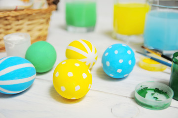 Close up of colorful Easter eggs in a basket. brush and paint