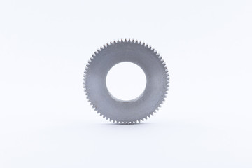 Isolated metal pinions gear. The iron gear on a white background. Pinions in the gearbox. Parts to the gear mechanism. Sprockets to clockwork. Shiny gear ready for assembly.