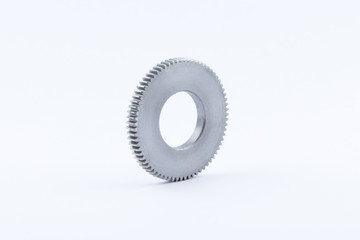 Isolated metal pinions gear. The iron gear on a white background. Pinions in the gearbox. Parts to...