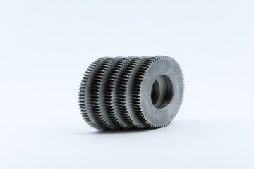 Isolated metal pinions gear. The iron gear on a white background. Pinions in the gearbox. Parts to the gear mechanism. Sprockets to clockwork. Shiny gear ready for assembly.