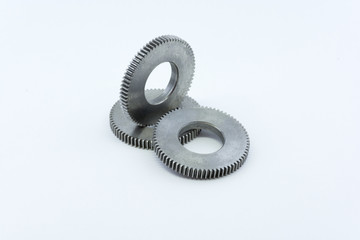 Isolated metal pinions gear. The iron gear on a white background. Pinions in the gearbox. Parts to...