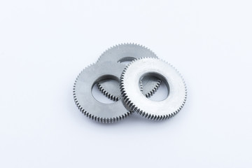 Isolated metal pinions gear. The iron gear on a white background. Pinions in the gearbox. Parts to...