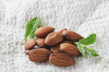 On a light towel a handful of ripe peeled crispy almonds