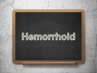 Medicine concept: Hemorrhoid on chalkboard background