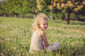 Fototapeta na wymiar lonely girl in green spring meadow