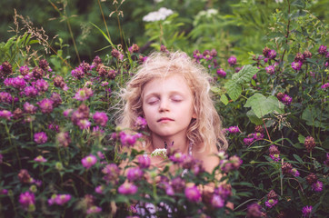 child in floral meadow