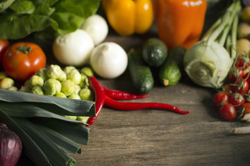 Young spring vegetables on black wood. Background with place for text