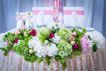 The table of the newlyweds decorated with pink hydrangeas and green colors, bright and juicy hydrangea
