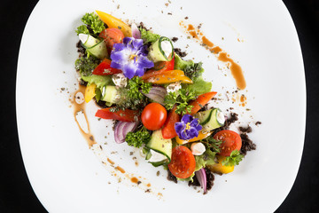 Greek salad fresh vegetables with feta cheese and grated black olives.