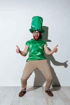 Full length of screaming man in green costume