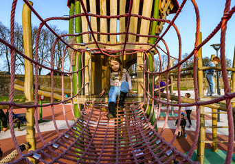 Cute little girl playing on the childre playground