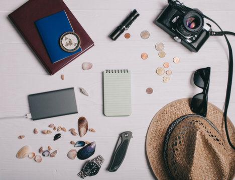 Travel concept, documents, hat, compass, money, phone and camera on a wooden background