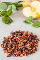 Mix of dry tea flavored with flowers and fruits on white background