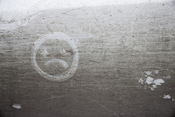 Painted sad smile on dirty background
