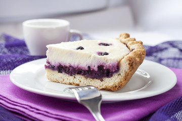 Piece of cheesecake with blueberries on a plate