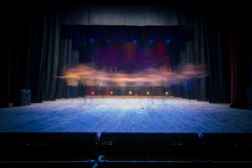 An empty stage of the theater, lit by spotlights before the performance