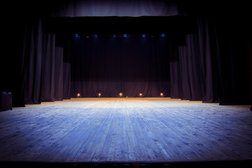 An empty stage of the theater, lit by spotlights before the performance