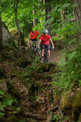 Couple Mountain Biking on Single Track in the Forest