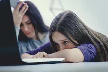 Scared mother arguing daughter over online activity. Cyber bullying or blue whale game concept