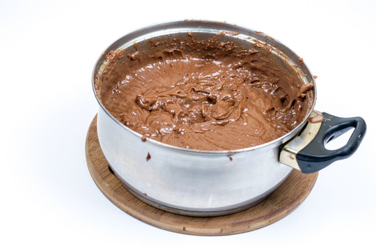 Chocolate cream in the mixing bowl over white background