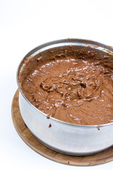 Chocolate cream in the mixing bowl over white background