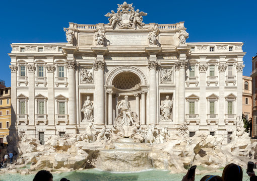 Rome, Italy - March 1, 2017: Tourists in front of the magnificent "Trevi Fountain." Some take pictures, others do selfies.